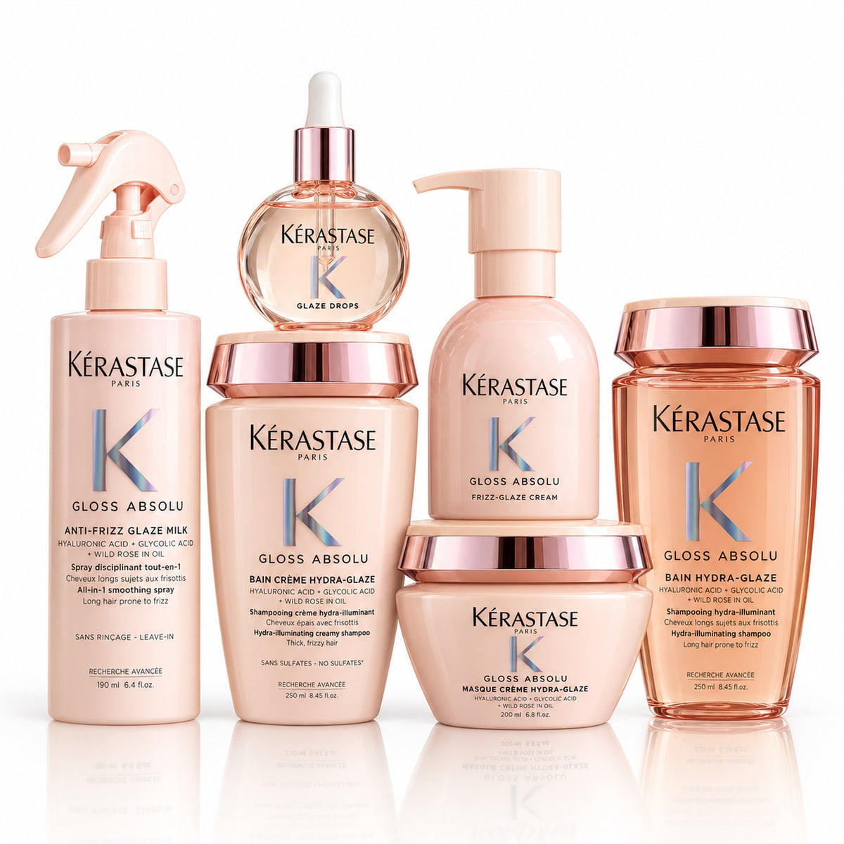 Kit Kérastase Gloss Absolu de seis productos sobre fondo blanco: dos shampoos, mascarilla, spray, crema y aceite.