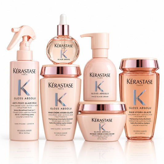 Kit Kérastase Gloss Absolu de seis productos sobre fondo blanco: dos shampoos, mascarilla, spray, crema y aceite.