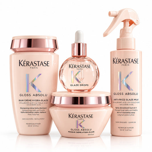 Kit Kérastase Gloss Absolu sobre fondo blanco con shampoo cremoso, mascarilla Crème Hydra-Glaze, spray y aceite Glaze Drops.
