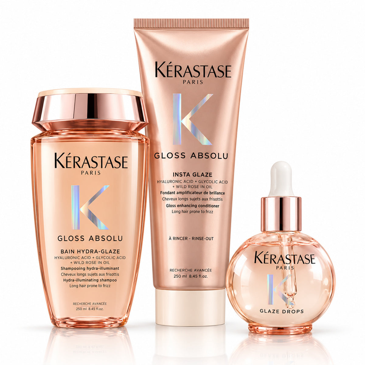 Pack Kérastase Gloss Absolu de tres productos sobre fondo blanco: shampoo Hydra-Glaze, acondicionador Insta Glaze y aceite Glaze Drops.